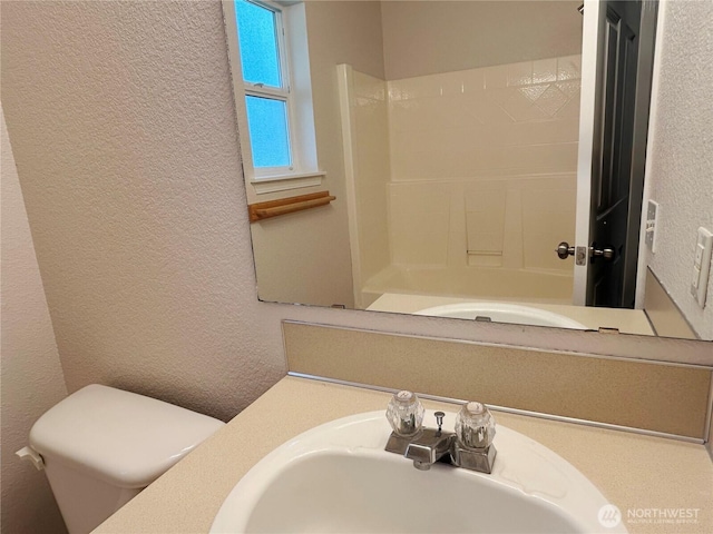 9002 Shadberry Dr SE, Olympia, WA 98513 - full bathroom featuring a textured wall, toilet, vanity, and shower / washtub combination
