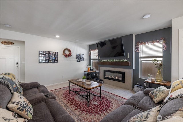 15028 Iverson Loop SE, Yelm, WA 98597 - living room with a glass covered fireplace, plenty of natural light, wood finished floors, and recessed lighting