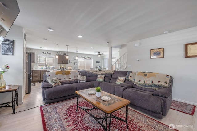 15028 Iverson Loop SE, Yelm, WA 98597 - living area featuring light wood finished floors, stairway, ceiling fan, recessed lighting, and baseboards