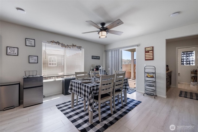 15028 Iverson Loop SE, Yelm, WA 98597 - dining room with ceiling fan, light wood-style floors, and baseboards