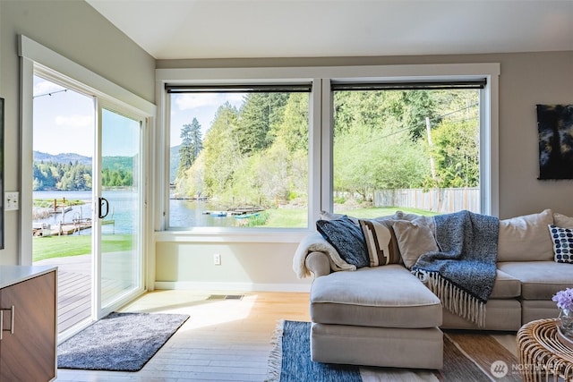 2 Greene Point Rd, Bellingham, WA 98229 - living area featuring plenty of natural light, wood finished floors, a water view, baseboards, and vaulted ceiling