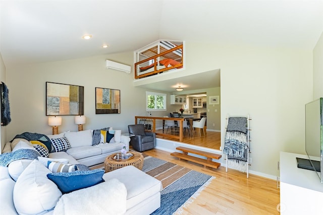 2 Greene Point Rd, Bellingham, WA 98229 - living area with a wall unit AC, wood finished floors, baseboards, and high vaulted ceiling