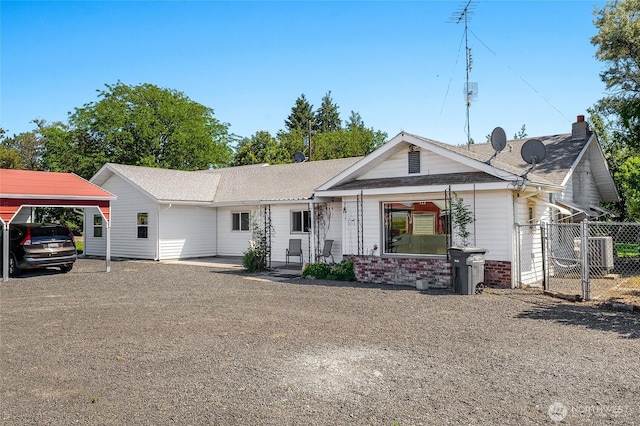 11801 Rd K NE, Moses Lake, WA 98837 - view of front of property with central air condition unit, a gate, brick siding, and a shingled roof