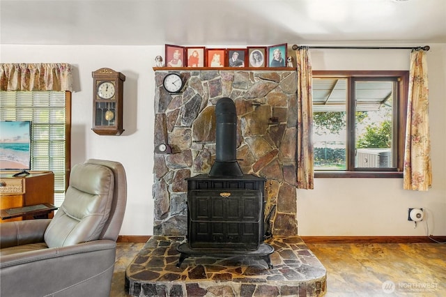11801 Rd K NE, Moses Lake, WA 98837 - living area featuring a wood stove, baseboards, and healthy amount of natural light