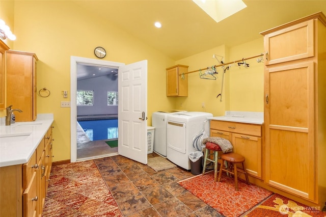 11801 Rd K NE, Moses Lake, WA 98837 - laundry area featuring cabinet space, washer and dryer, a skylight, dark stone finish flooring, and recessed lighting