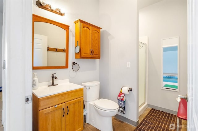 11801 Rd K NE, Moses Lake, WA 98837 - full bathroom featuring vanity, toilet, an enclosed shower, and baseboards