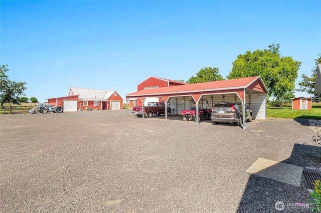 11801 Rd K NE, Moses Lake, WA 98837 - view of parking / parking lot with a detached carport and a storage unit