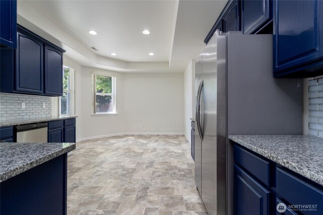 78 Cranbrook Ln, Walla Walla, WA 99362 - kitchen with appliances with stainless steel finishes, blue cabinetry, decorative backsplash, recessed lighting, and a tray ceiling