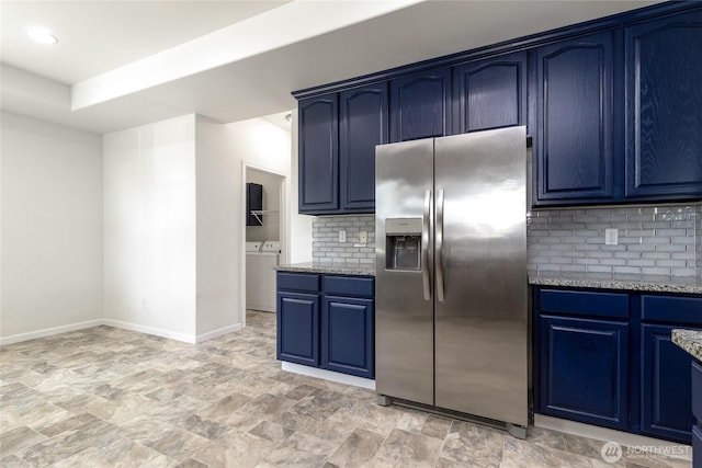 78 Cranbrook Ln, Walla Walla, WA 99362 - kitchen featuring stainless steel fridge with ice dispenser, blue cabinetry, light stone countertops, decorative backsplash, and washer and dryer