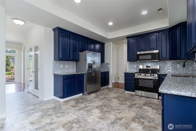 78 Cranbrook Ln, Walla Walla, WA 99362 - kitchen with stainless steel appliances, backsplash, blue cabinetry, light stone countertops, and light stone finish floors