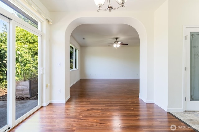 78 Cranbrook Ln, Walla Walla, WA 99362 - unfurnished room featuring arched walkways, wood finished floors, a chandelier, and a ceiling fan