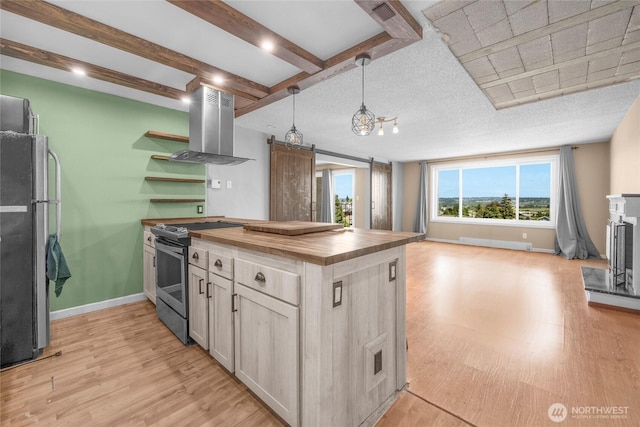 3425 Colby Ave Unit 601, Everett, WA 98201 - kitchen featuring electric stove, wooden counters, island exhaust hood, light wood-style floors, and freestanding refrigerator