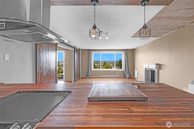 3425 Colby Ave Unit 601, Everett, WA 98201 - unfurnished living room with wood finished floors, a fireplace, and a textured ceiling