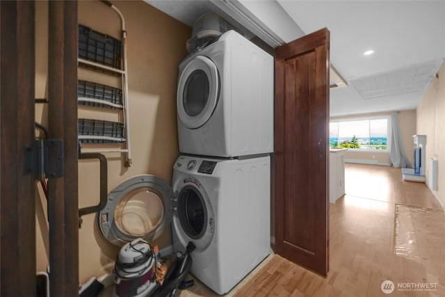 3425 Colby Ave Unit 601, Everett, WA 98201 - washroom with stacked washer and clothes dryer, light wood finished floors, and recessed lighting