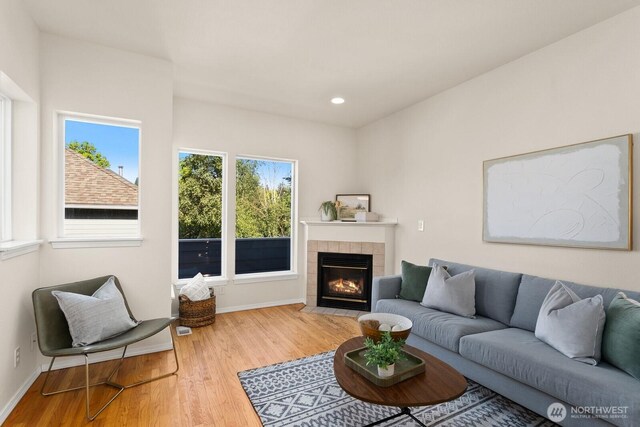 212 27th Ave E, Seattle, WA 98112 - living room featuring a tile fireplace, wood finished floors, baseboards, and recessed lighting