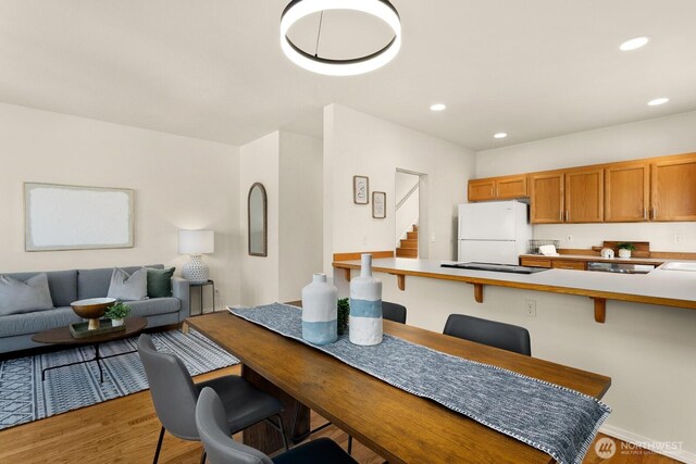 212 27th Ave E, Seattle, WA 98112 - dining space with light wood-style floors, stairway, and recessed lighting
