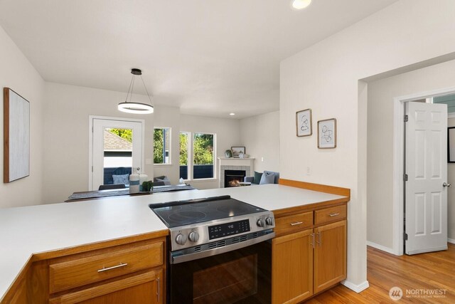 212 27th Ave E, Seattle, WA 98112 - kitchen with electric range, open floor plan, light countertops, light wood-style flooring, and recessed lighting