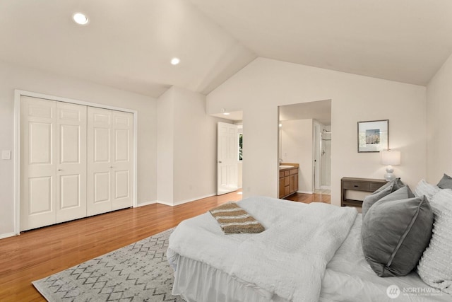 212 27th Ave E, Seattle, WA 98112 - bedroom with vaulted ceiling, light wood-type flooring, recessed lighting, baseboards, and ensuite bathroom