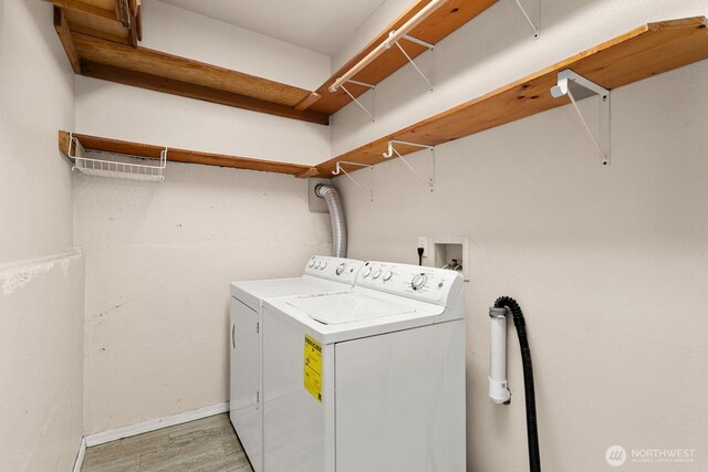212 27th Ave E, Seattle, WA 98112 - laundry room with washing machine and clothes dryer, light wood-style floors, and baseboards
