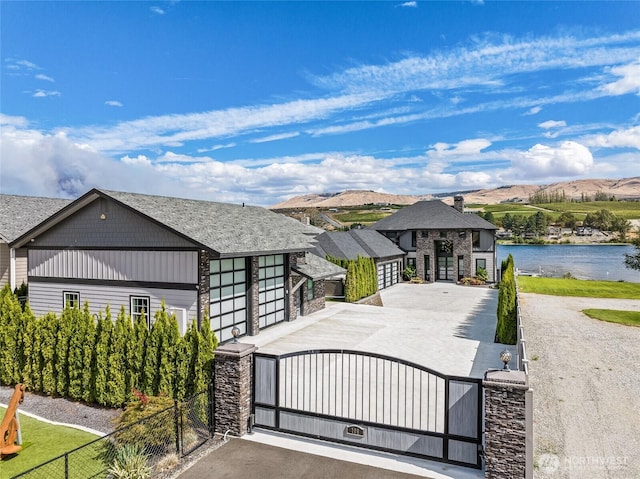 106 Shypoke Pl, Entiat, WA 98822 - view of front of house featuring a fenced front yard, a gate, stone siding, and a water view
