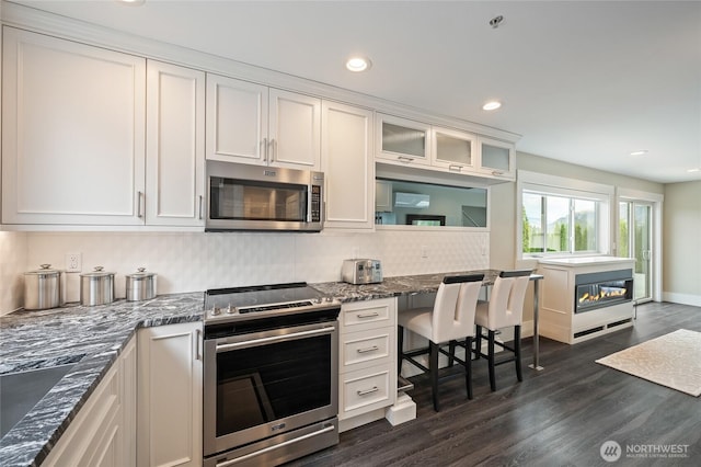 106 Shypoke Pl, Entiat, WA 98822 - kitchen featuring stainless steel appliances, white cabinets, dark wood-type flooring, tasteful backsplash, and recessed lighting