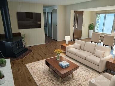 2200 196th St SE Unit 45, Bothell, WA 98012 - living area with a wood stove, wood finished floors, and baseboards