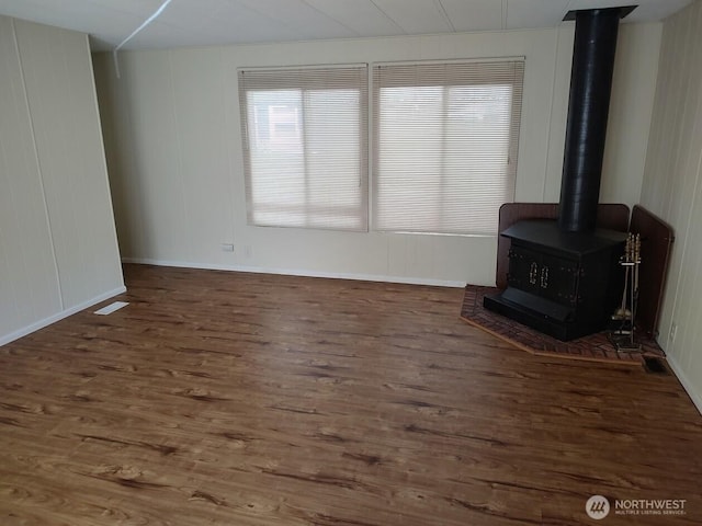 2200 196th St SE Unit 45, Bothell, WA 98012 - unfurnished living room featuring a wood stove, wood finished floors, and baseboards