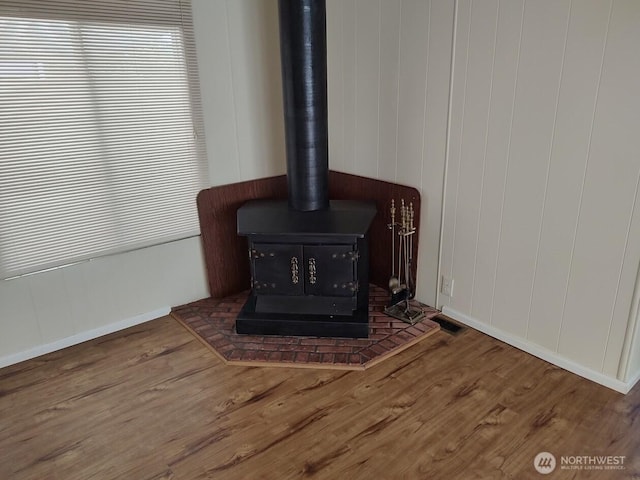 2200 196th St SE Unit 45, Bothell, WA 98012 - detailed view of a wood stove, wood finished floors, and baseboards