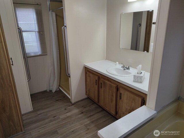 2200 196th St SE Unit 45, Bothell, WA 98012 - bathroom with wood finished floors, vanity, and a shower with shower curtain