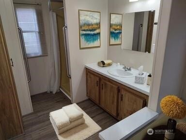 2200 196th St SE Unit 45, Bothell, WA 98012 - bathroom with wood finished floors, vanity, and an enclosed shower