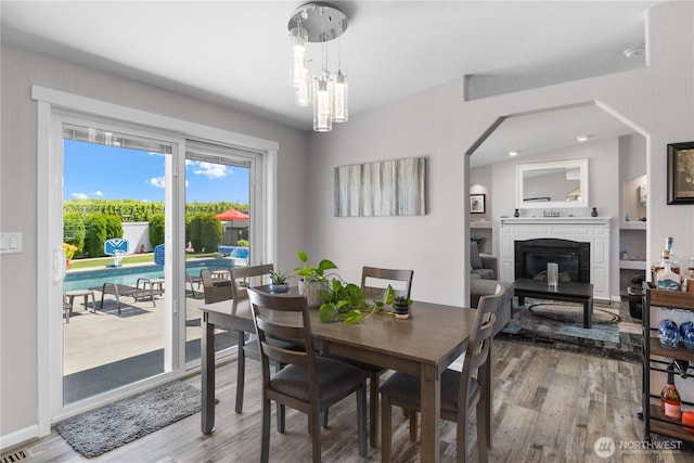 207 Moon River Vw SW, Mattawa, WA 99349 - dining space featuring a glass covered fireplace, wood finished floors, and baseboards