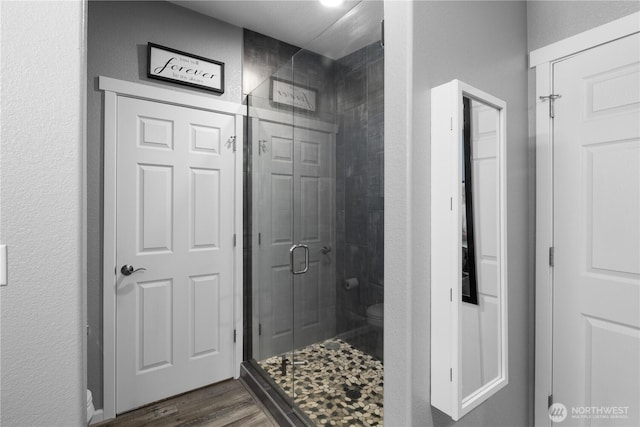 207 Moon River Vw SW, Mattawa, WA 99349 - full bath featuring toilet, a stall shower, wood finished floors, and a textured wall