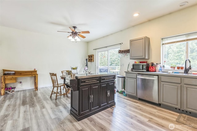 642 Sprague Valley Dr, Maple Falls, WA 98266 - kitchen with stainless steel appliances, a sink, ceiling fan, light wood-type flooring, and light countertops