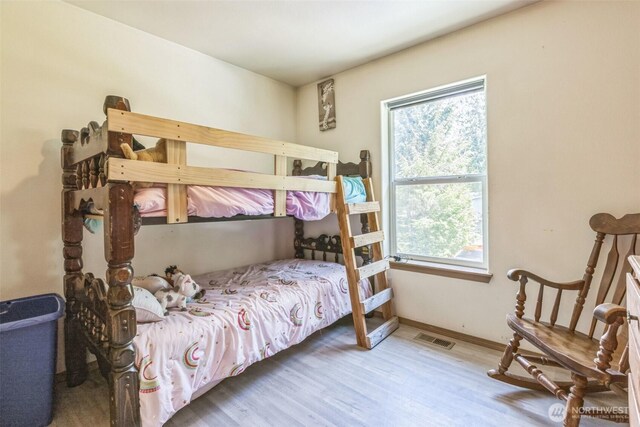 642 Sprague Valley Dr, Maple Falls, WA 98266 - bedroom featuring multiple windows, wood finished floors, and baseboards