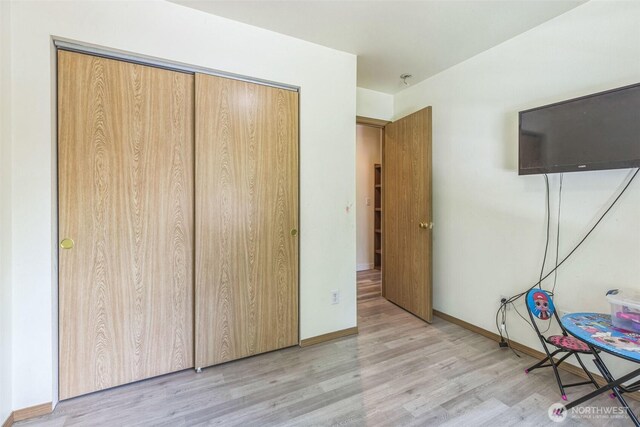 642 Sprague Valley Dr, Maple Falls, WA 98266 - unfurnished bedroom with wood finished floors, baseboards, and a closet