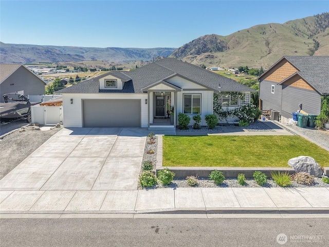 1080 Sunset Ln, Chelan, WA 98816 - view of front of house with a mountain view, driveway, an attached garage, and cooling unit
