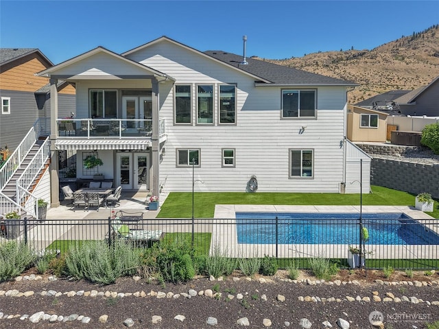 1080 Sunset Ln, Chelan, WA 98816 - back of property featuring a patio, a balcony, and a mountain view