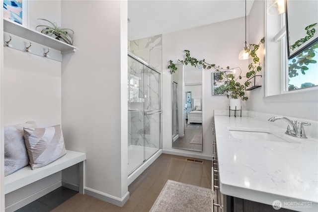1080 Sunset Ln, Chelan, WA 98816 - full bathroom with a marble finish shower, vanity, and baseboards