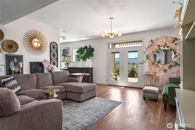 1080 Sunset Ln, Chelan, WA 98816 - living room with wood finished floors, a chandelier, and french doors