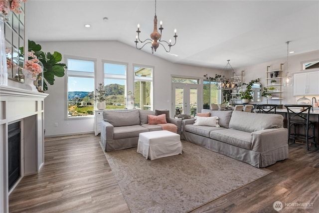 1080 Sunset Ln, Chelan, WA 98816 - living room with a chandelier, french doors, a fireplace, wood finished floors, and lofted ceiling