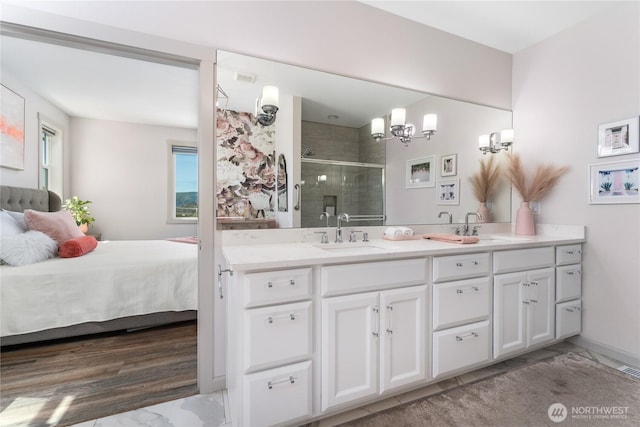 1080 Sunset Ln, Chelan, WA 98816 - bathroom with a stall shower, double vanity, a chandelier, and marble finish floors