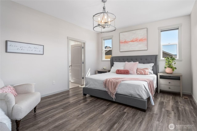 1080 Sunset Ln, Chelan, WA 98816 - bedroom featuring a chandelier, wood finished floors, baseboards, and connected bathroom