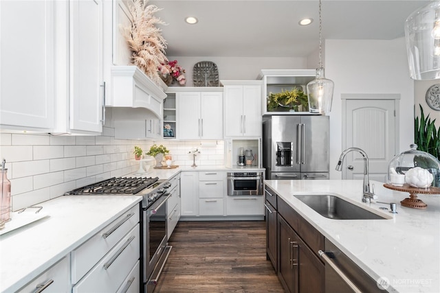 1080 Sunset Ln, Chelan, WA 98816 - kitchen featuring stainless steel appliances, a sink, white cabinets, decorative backsplash, and dark wood-type flooring