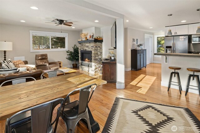 671 W Pacific Ave, Ronald, WA 98940 - living area featuring light wood finished floors, healthy amount of natural light, a stone fireplace, a ceiling fan, and recessed lighting
