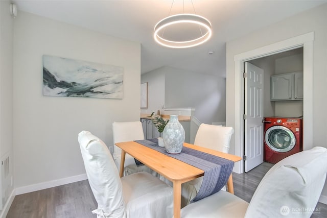 300 Cascade Ave, Granite Falls, WA 98252 - dining room with washer / clothes dryer, wood finished floors, and a chandelier