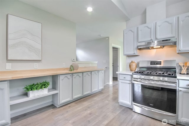 300 Cascade Ave, Granite Falls, WA 98252 - kitchen featuring gas range, under cabinet range hood, light wood finished floors, and open shelves