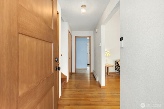1642 Browns Point Blvd, Tacoma, WA 98422 - hallway featuring a baseboard radiator, light wood finished floors, and baseboards