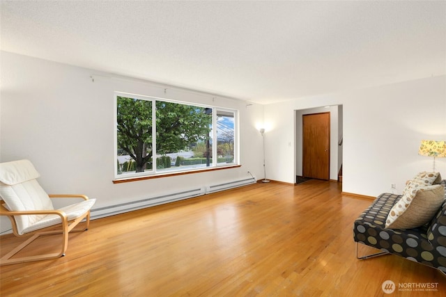 1642 Browns Point Blvd, Tacoma, WA 98422 - living area with a baseboard radiator, light wood finished floors, and baseboards