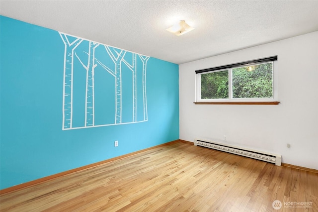 1642 Browns Point Blvd, Tacoma, WA 98422 - spare room with baseboard heating, a textured ceiling, wood finished floors, and baseboards