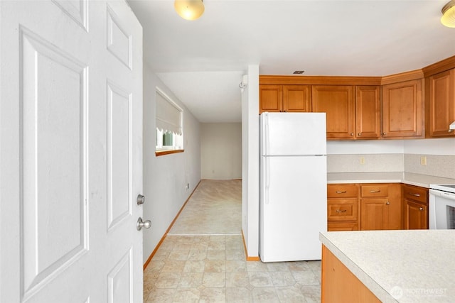 1642 Browns Point Blvd, Tacoma, WA 98422 - kitchen featuring white appliances, light countertops, and brown cabinets